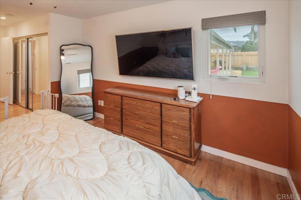 14539 Kennebunk Street Poway, CA 92064 - Photo 18 of 26 a bedroom with a bed and a flat tv screen on dresser