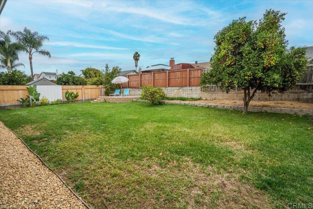 14539 Kennebunk Street Poway, CA 92064 - Photo 22 of 26 a view of a garden with a building in the background