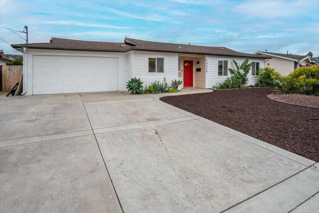 14539 Kennebunk Street Poway, CA 92064 - Photo 3 of 26 a front view of a house with garage and plants