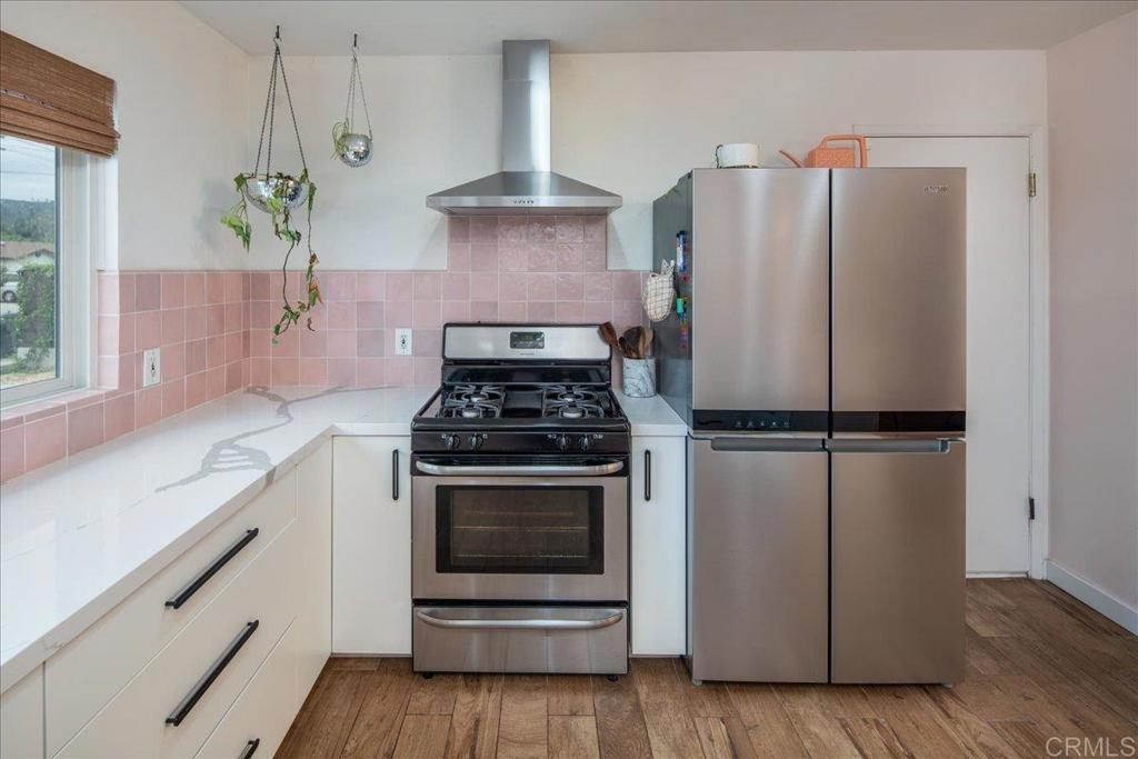 14539 Kennebunk Street Poway, CA 92064 - Photo 9 of 26 a kitchen with a stove and a refrigerator