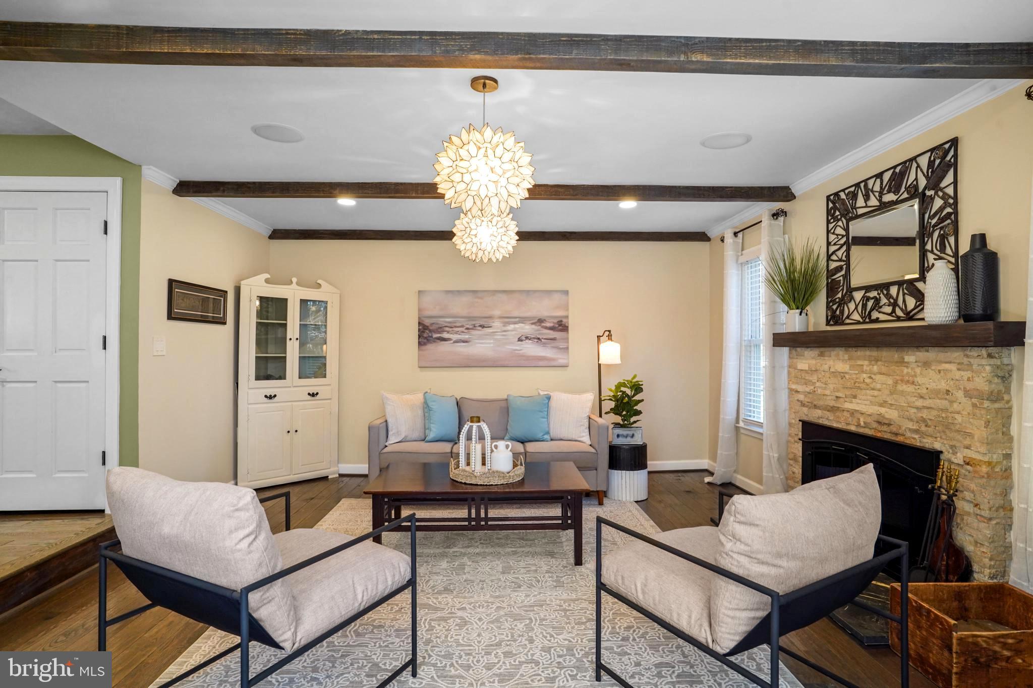 9036 Brook Ford Road Burke, VA 22015 - Photo 12 of 40 a living room with furniture chandelier and a fireplace