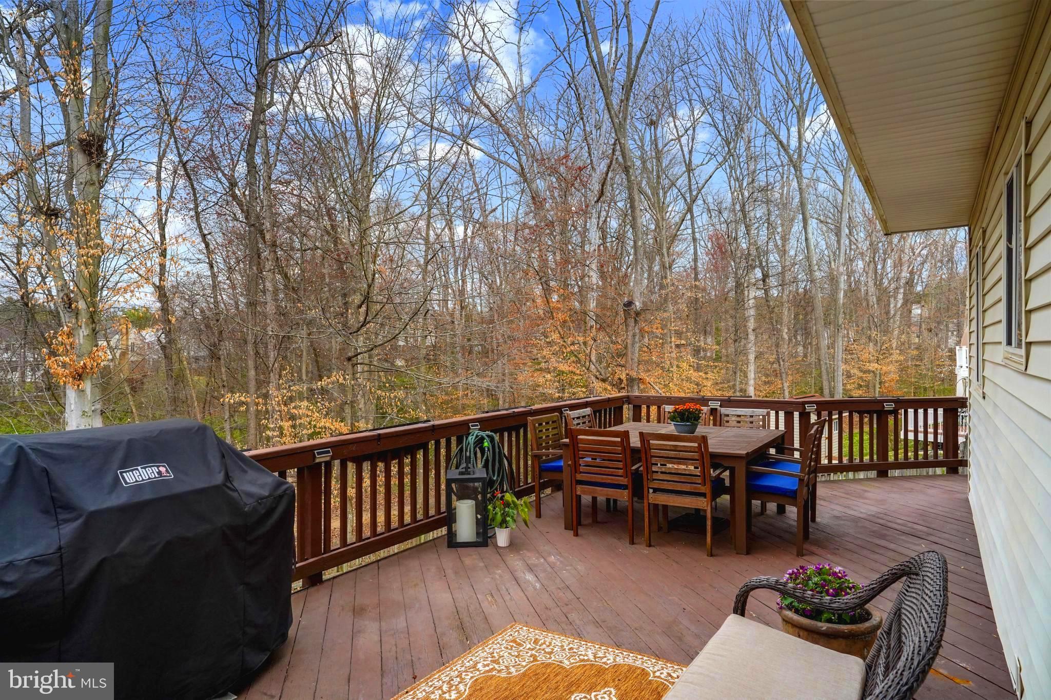 9036 Brook Ford Road Burke, VA 22015 - Photo 15 of 40 a view of a chairs in wooden deck