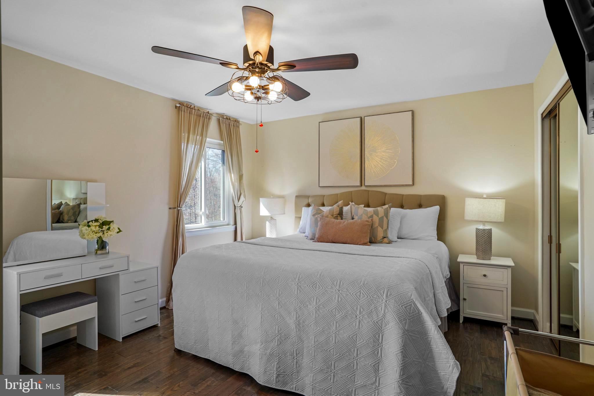 9036 Brook Ford Road Burke, VA 22015 - Photo 24 of 40 a bedroom with a bed and a chandelier