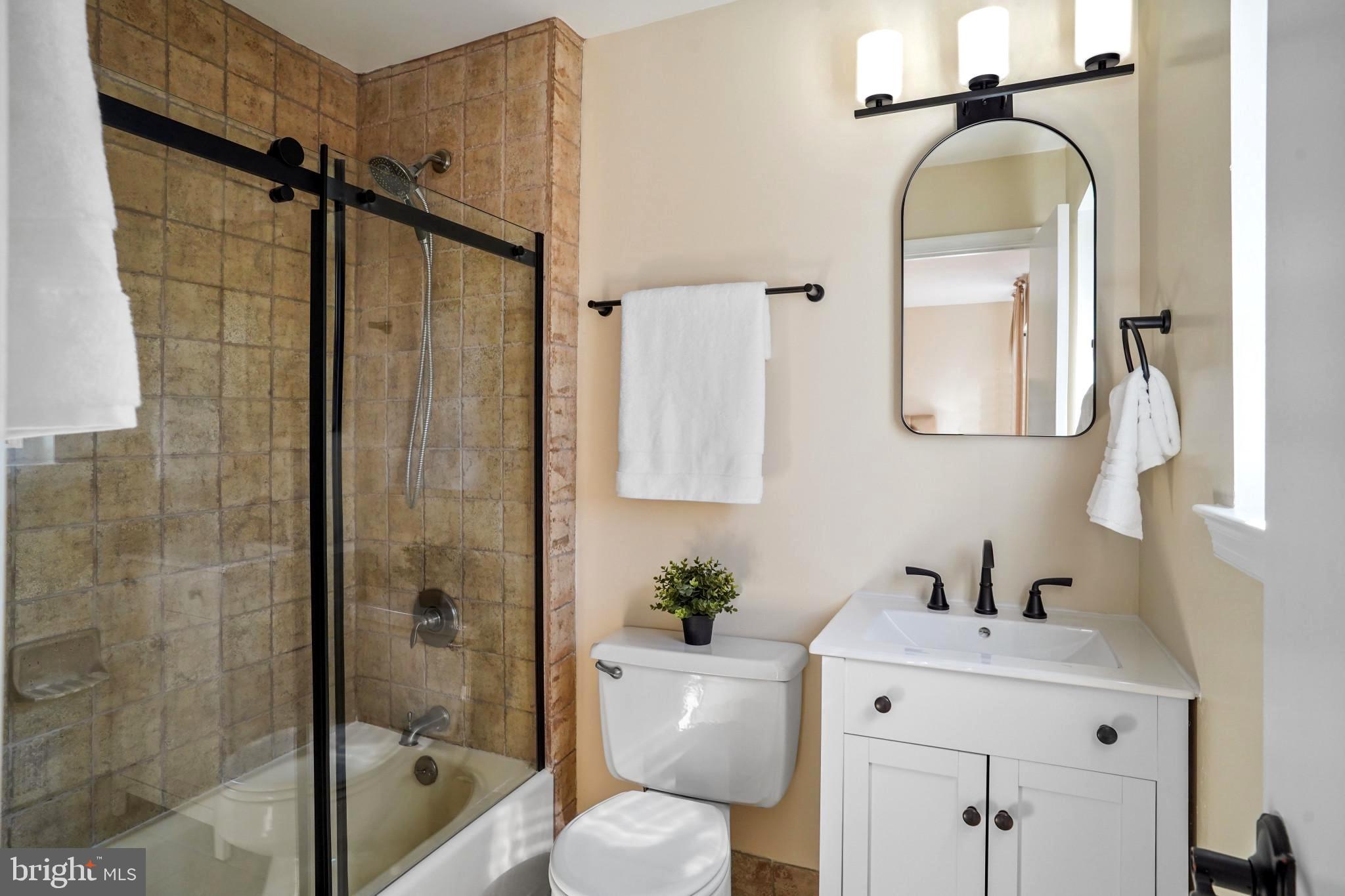 9036 Brook Ford Road Burke, VA 22015 - Photo 26 of 40 a bathroom with a toilet sink vanity and shower