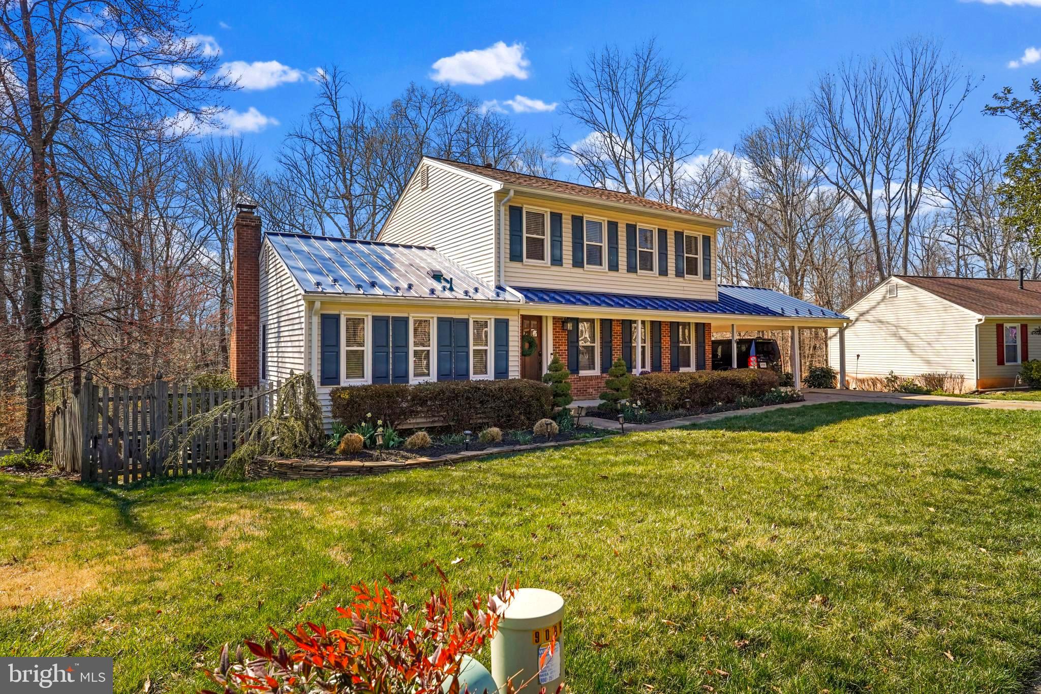 9036 Brook Ford Road Burke, VA 22015 - Photo 4 of 40 a front view of a house with a yard table and chairs