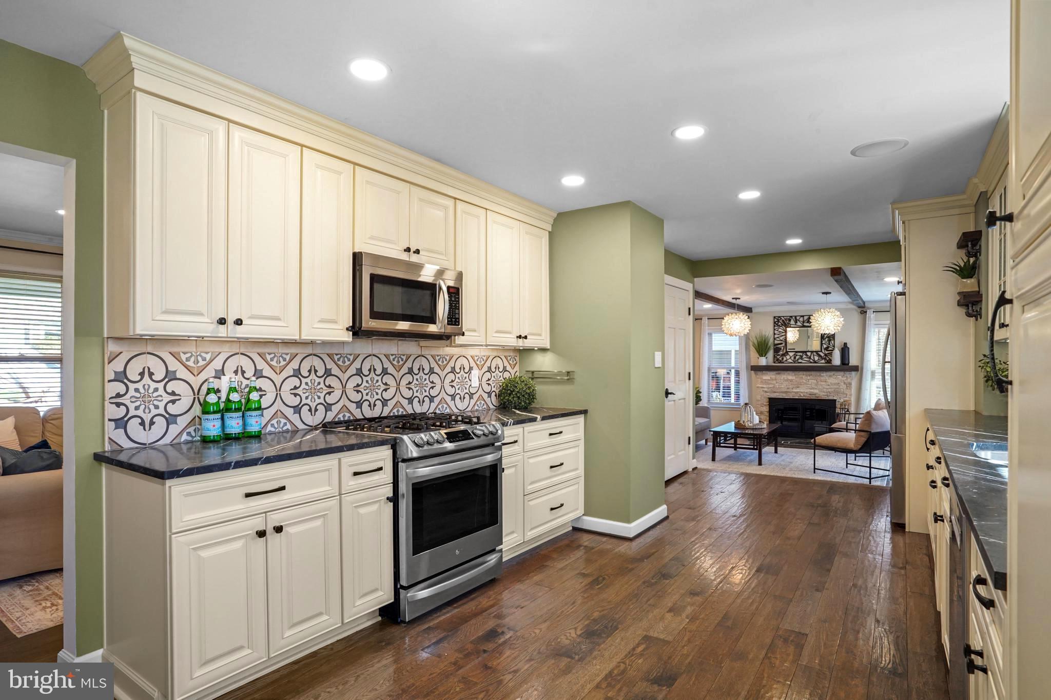 9036 Brook Ford Road Burke, VA 22015 - Photo 10 of 40 a kitchen with stainless steel appliances kitchen island granite countertop a stove a sink and a microwave