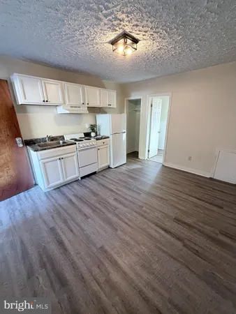 a large kitchen with stainless steel appliances granite countertop a stove and a refrigerator