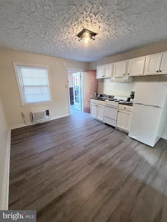 a large kitchen with stainless steel appliances granite countertop a stove and a refrigerator