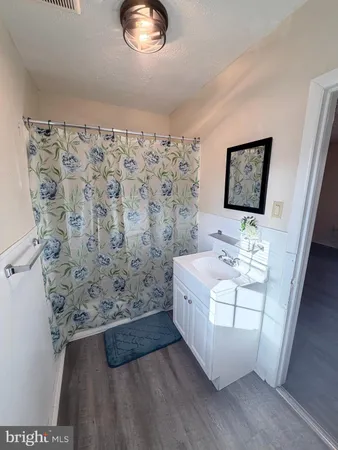 a bathroom with a sink a mirror and a shower