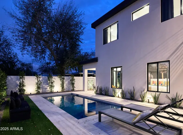 a view of swimming pool with chairs