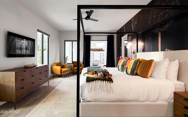 a bedroom with furniture and flat screen tv