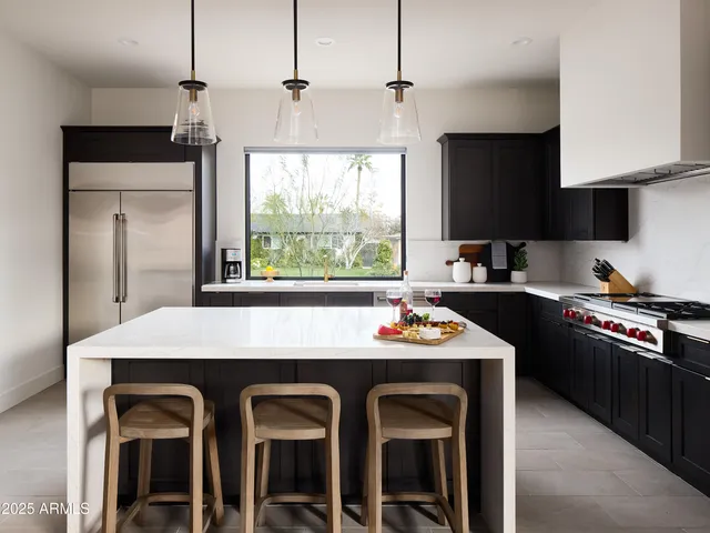 a kitchen with a stove a sink and a refrigerator