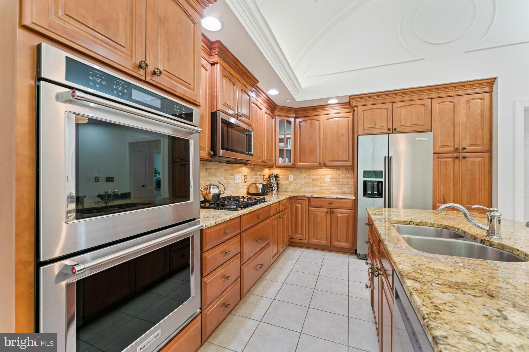 2411 Grand Oaks Court, Unit 30 Abingdon, MD 21009 - Photo 11 of 45 a kitchen with stainless steel appliances granite countertop a stove microwave and cabinets