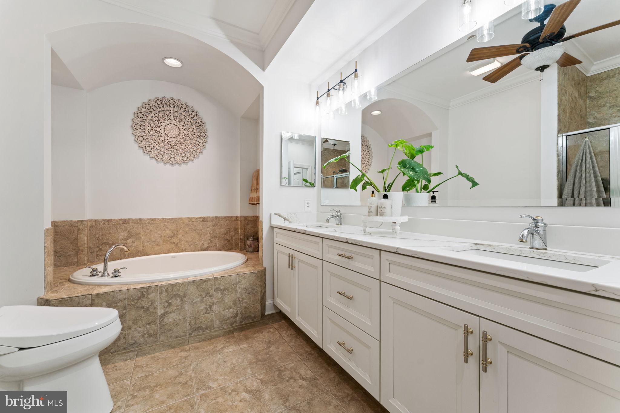 2411 Grand Oaks Court, Unit 30 Abingdon, MD 21009 - Photo 20 of 45 a bathroom with a double vanity sink a toilet and a bathtub