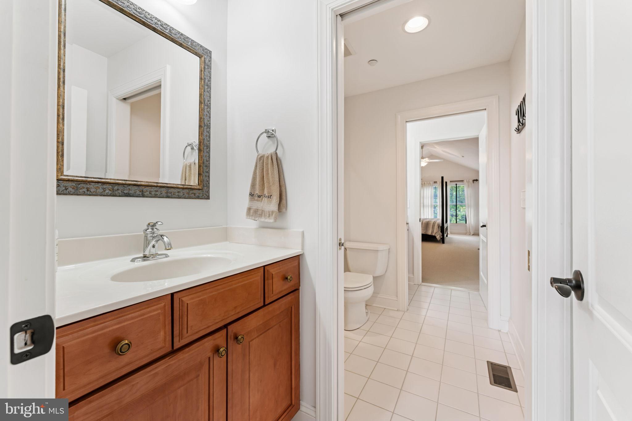 2411 Grand Oaks Court, Unit 30 Abingdon, MD 21009 - Photo 28 of 45 a bathroom with a sink a toilet and mirror
