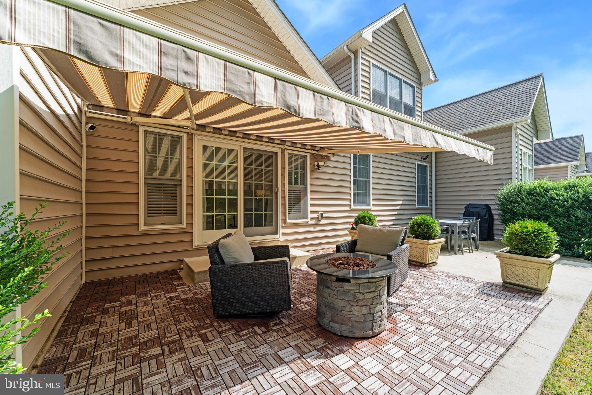 2411 Grand Oaks Court, Unit 30 Abingdon, MD 21009 - Photo 40 of 45 a view of a patio with table and chairs and wooden fence