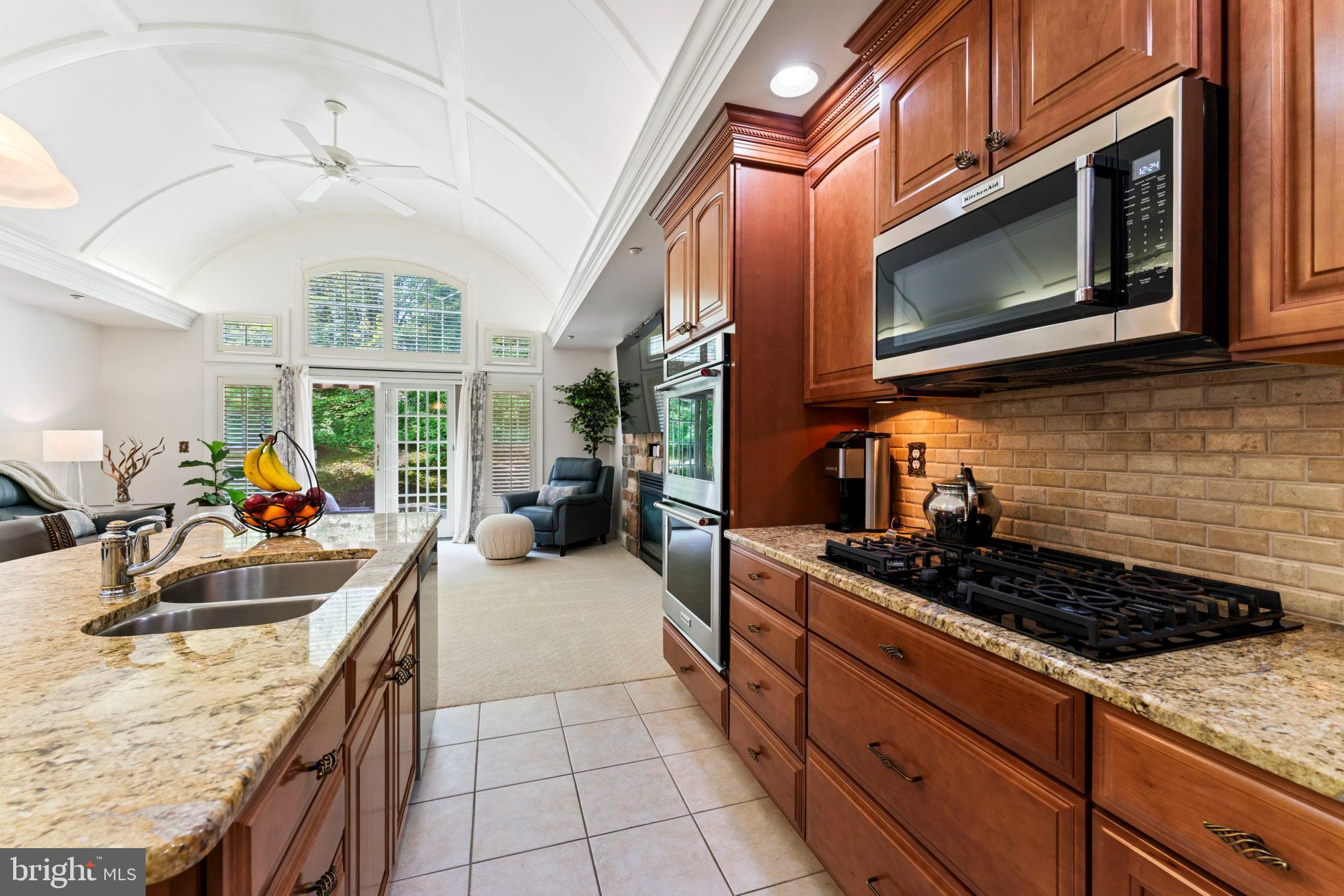 2411 Grand Oaks Court, Unit 30 Abingdon, MD 21009 - Photo 10 of 45 a kitchen with stainless steel appliances granite countertop a stove and a microwave