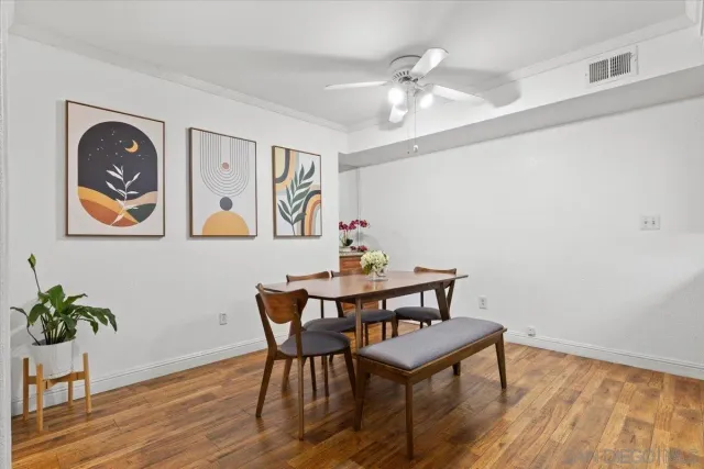 a view of a dining room with furniture and wooden floor