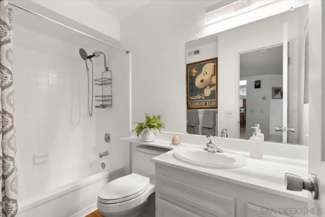 a bedroom with a bed window and a table