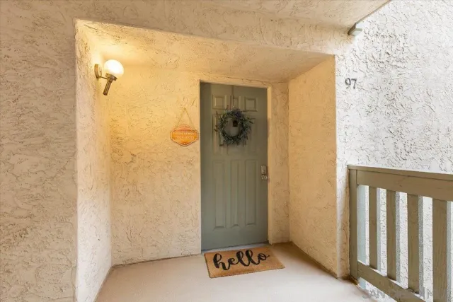 a living room with furniture large window and wooden floor