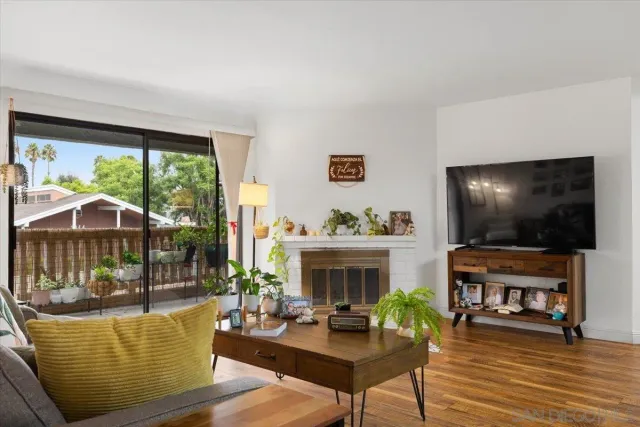 a living room with furniture and painting on the wall
