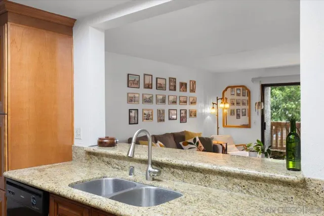 a spacious bathroom with a granite countertop sink and a mirror