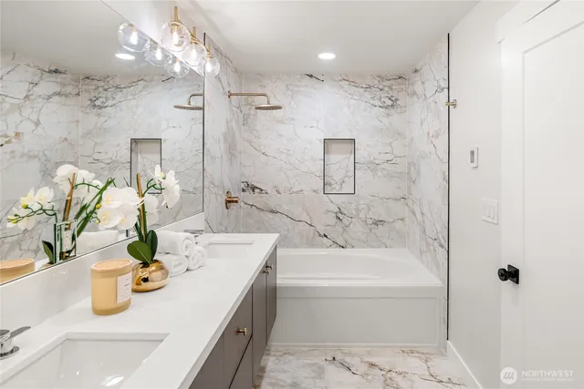 a bathroom with a granite countertop sink a mirror and shower