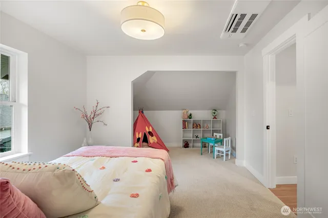 a bedroom with a bed and a large window