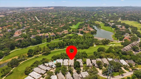 an aerial view of a golf course with a swimming pool