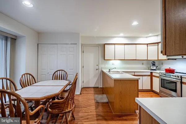 a kitchen that has a table and chairs in it