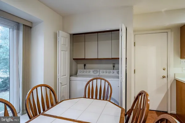 a view of a hallway with a door and furniture