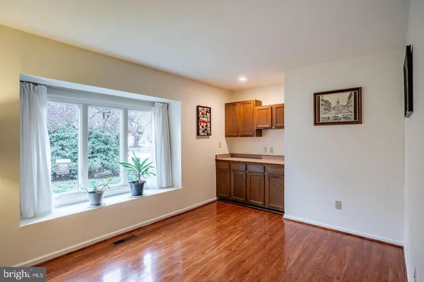 a view of a kitchen with a stove wooden floor and a window