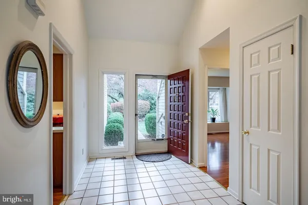 a view of an entryway with wooden floor and door