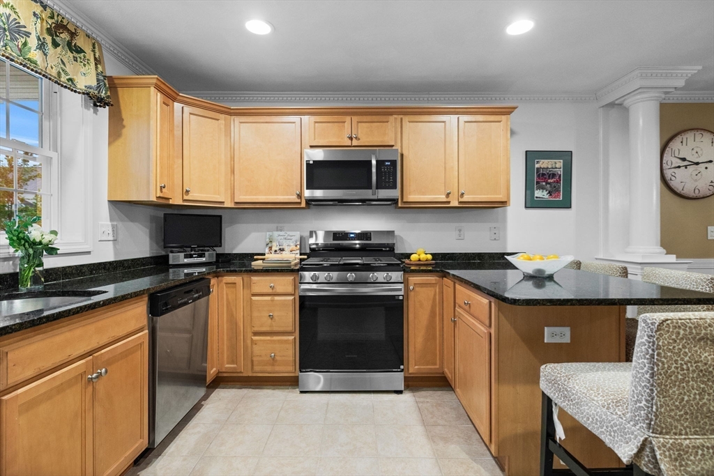 18 Dale Street, Unit 7A Andover, MA 01810 - Photo 11 of 34 a kitchen with stainless steel appliances granite countertop a stove a sink and a microwave