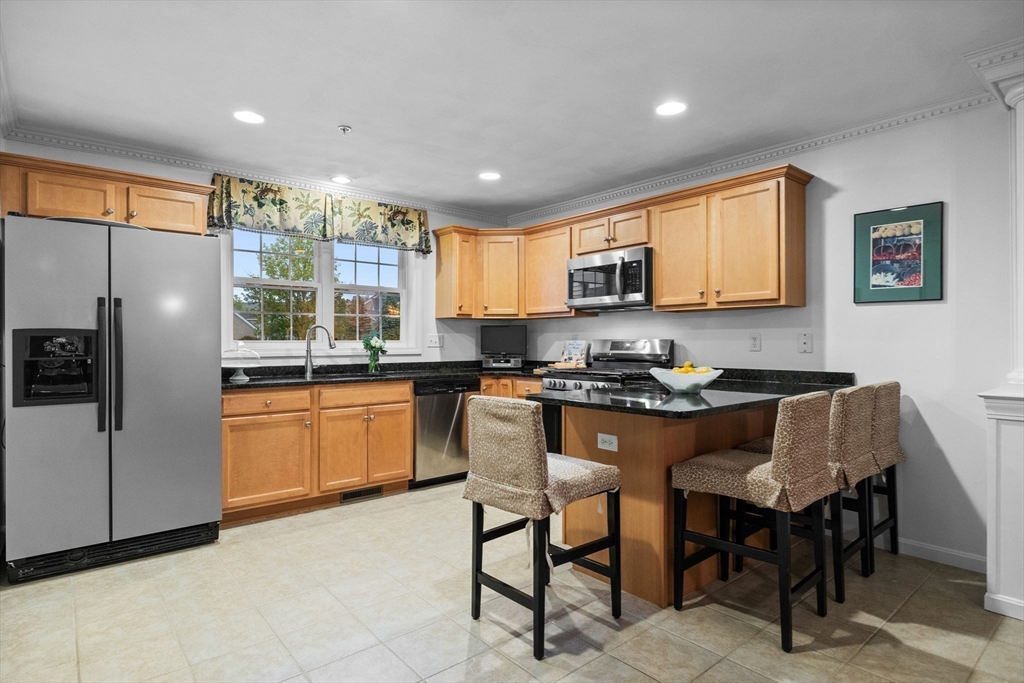 18 Dale Street, Unit 7A Andover, MA 01810 - Photo 12 of 34 a kitchen with stainless steel appliances granite countertop a stove a sink a refrigerator a dining table and chairs