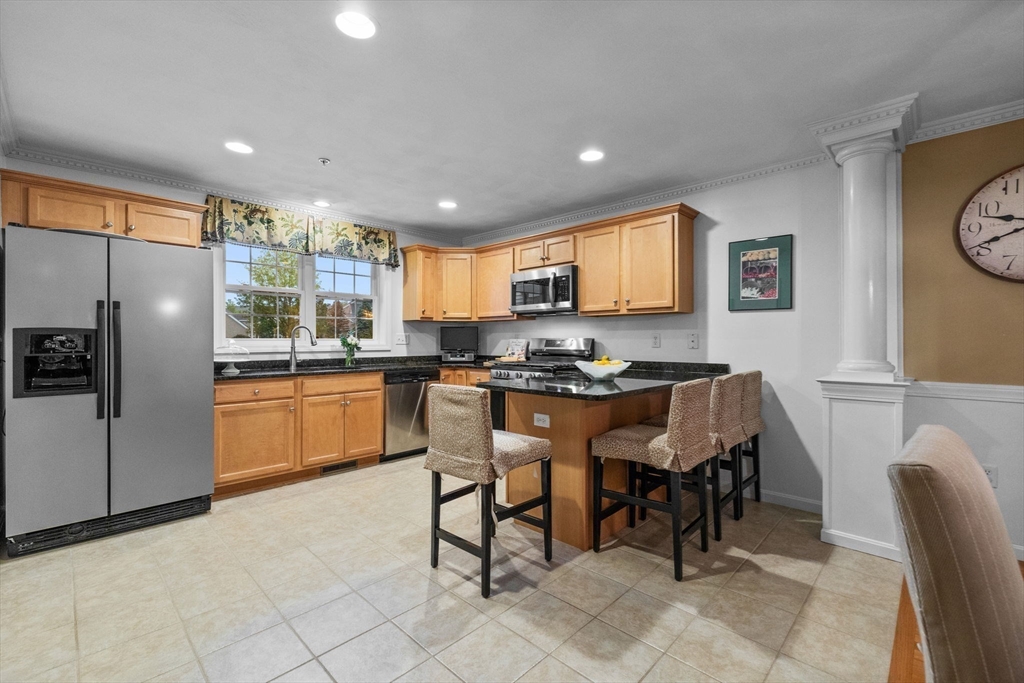 18 Dale Street, Unit 7A Andover, MA 01810 - Photo 13 of 34 a kitchen with granite countertop a stove a sink a refrigerator a dining table and chairs