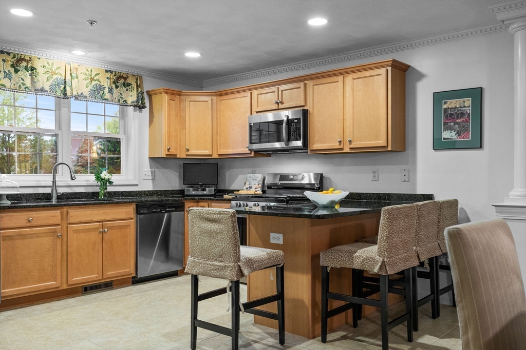 18 Dale Street, Unit 7A Andover, MA 01810 - Photo 14 of 34 a kitchen with stainless steel appliances granite countertop a stove a sink dishwasher a microwave oven with granite countertops and cabinets