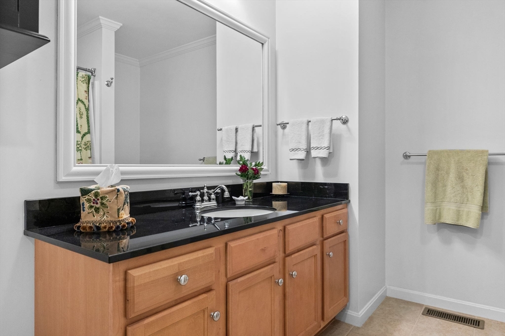 18 Dale Street, Unit 7A Andover, MA 01810 - Photo 22 of 34 a bathroom with a granite countertop sink and a mirror