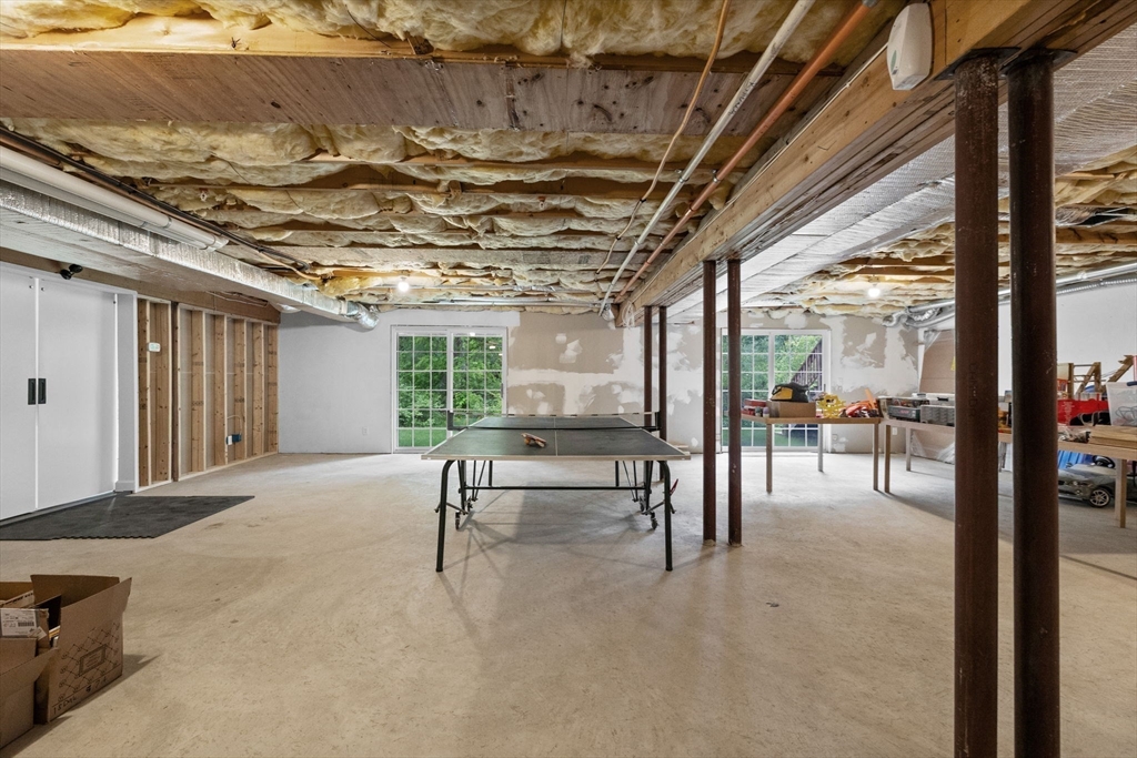 18 Dale Street, Unit 7A Andover, MA 01810 - Photo 31 of 34 a view of a patio with a table chairs and wooden fence