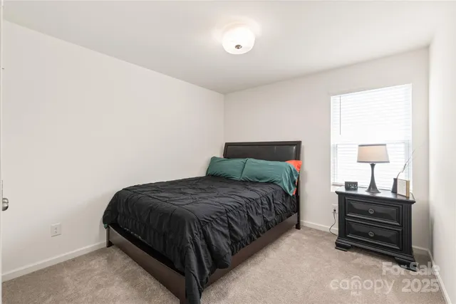 a bedroom with a bed and two lamp