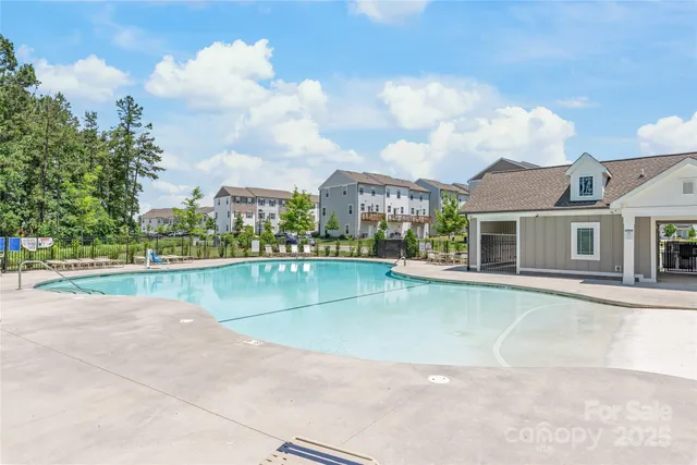 a view of swimming pool with a yard in front of it