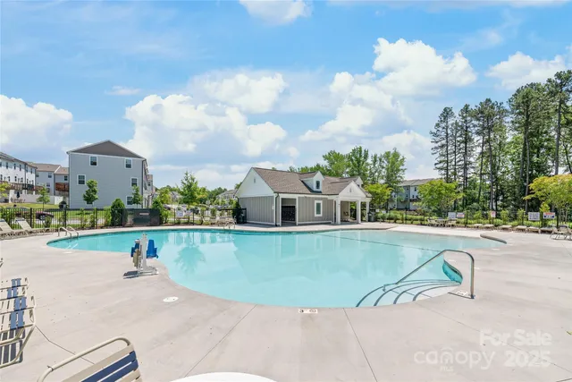an aerial view of a house with swimming pool garden and outdoor seating