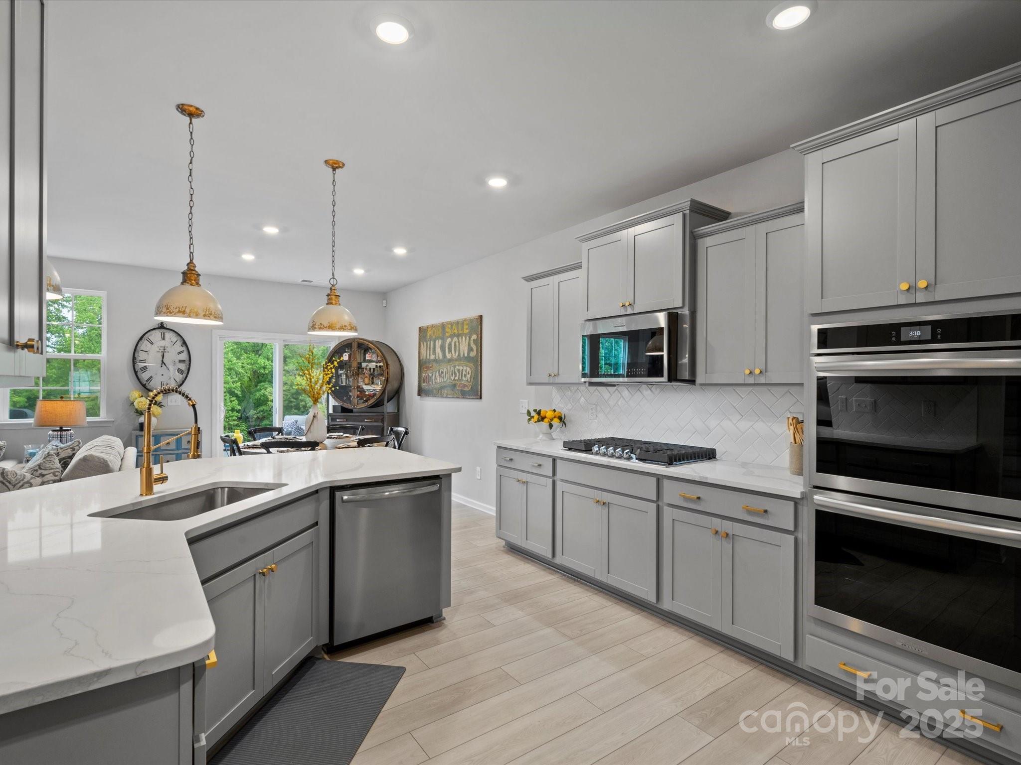 5581 Soft Shell Drive Lancaster, SC 29720 - Photo 14 of 48 a kitchen with stainless steel appliances granite countertop a sink a stove and a wooden floors