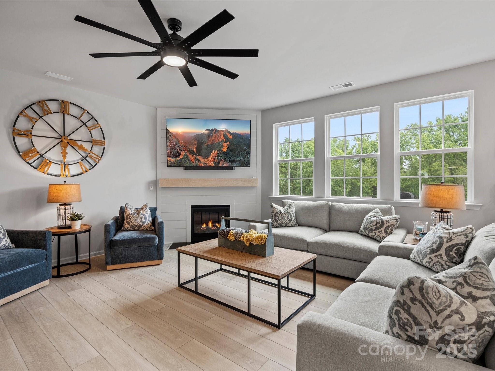 5581 Soft Shell Drive Lancaster, SC 29720 - Photo 16 of 48 a living room with furniture a fireplace and a large window