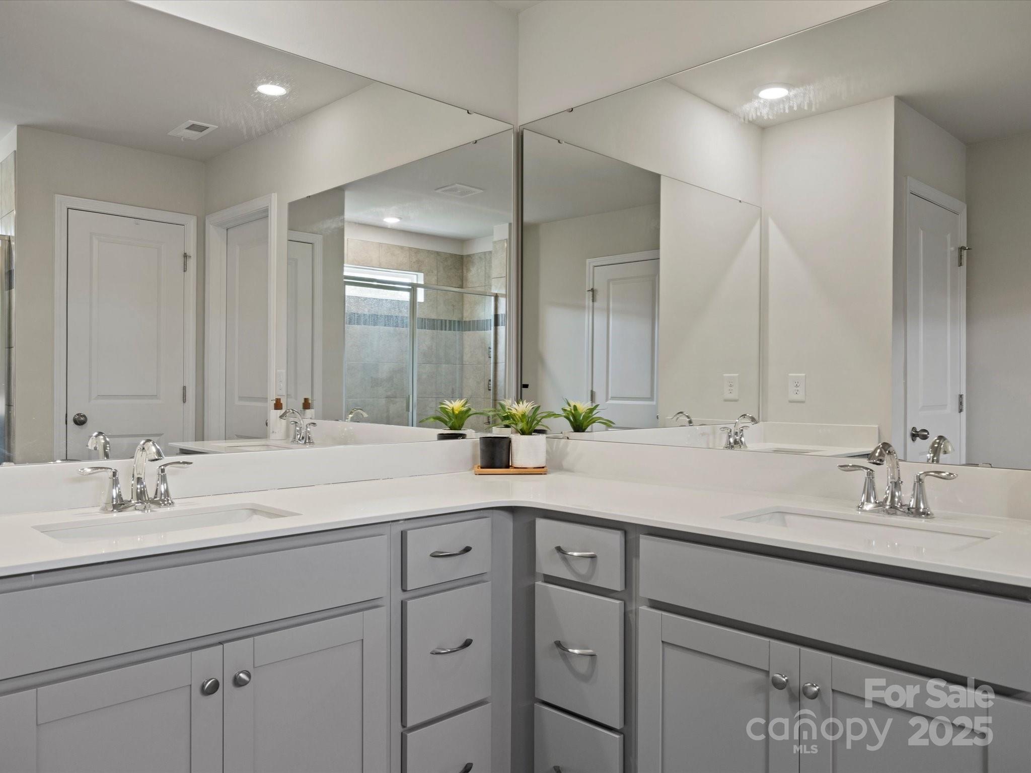5581 Soft Shell Drive Lancaster, SC 29720 - Photo 31 of 48 a bathroom with double sink and a mirror