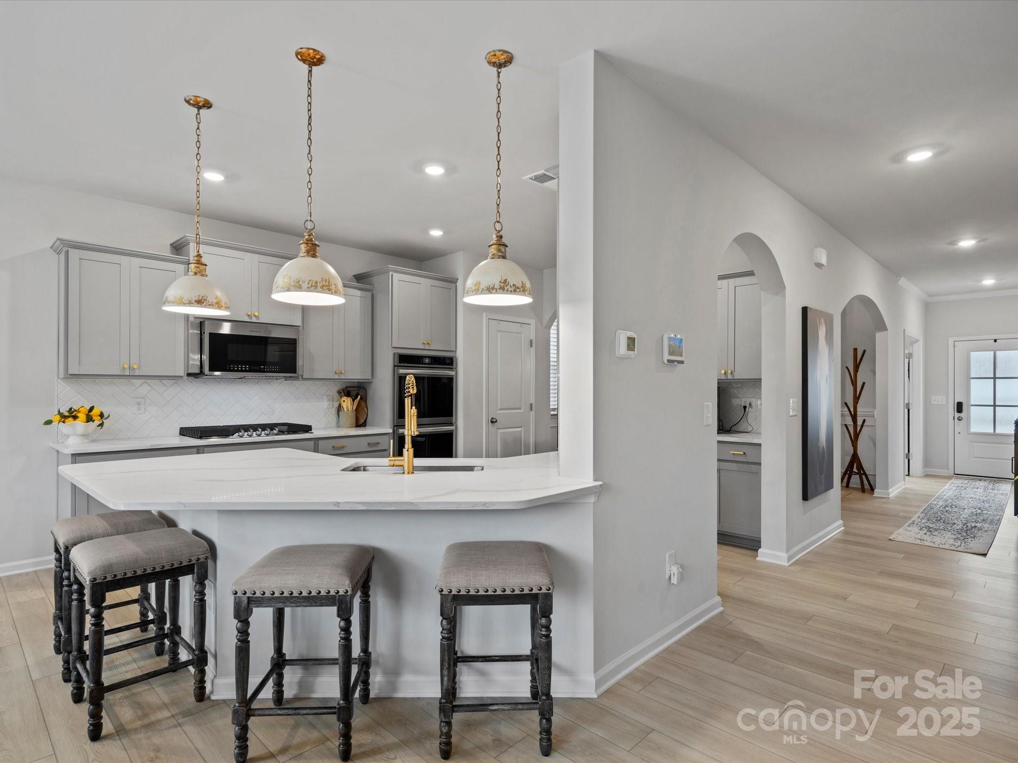 5581 Soft Shell Drive Lancaster, SC 29720 - Photo 8 of 48 a kitchen with stainless steel appliances kitchen island a refrigerator and a stove top oven