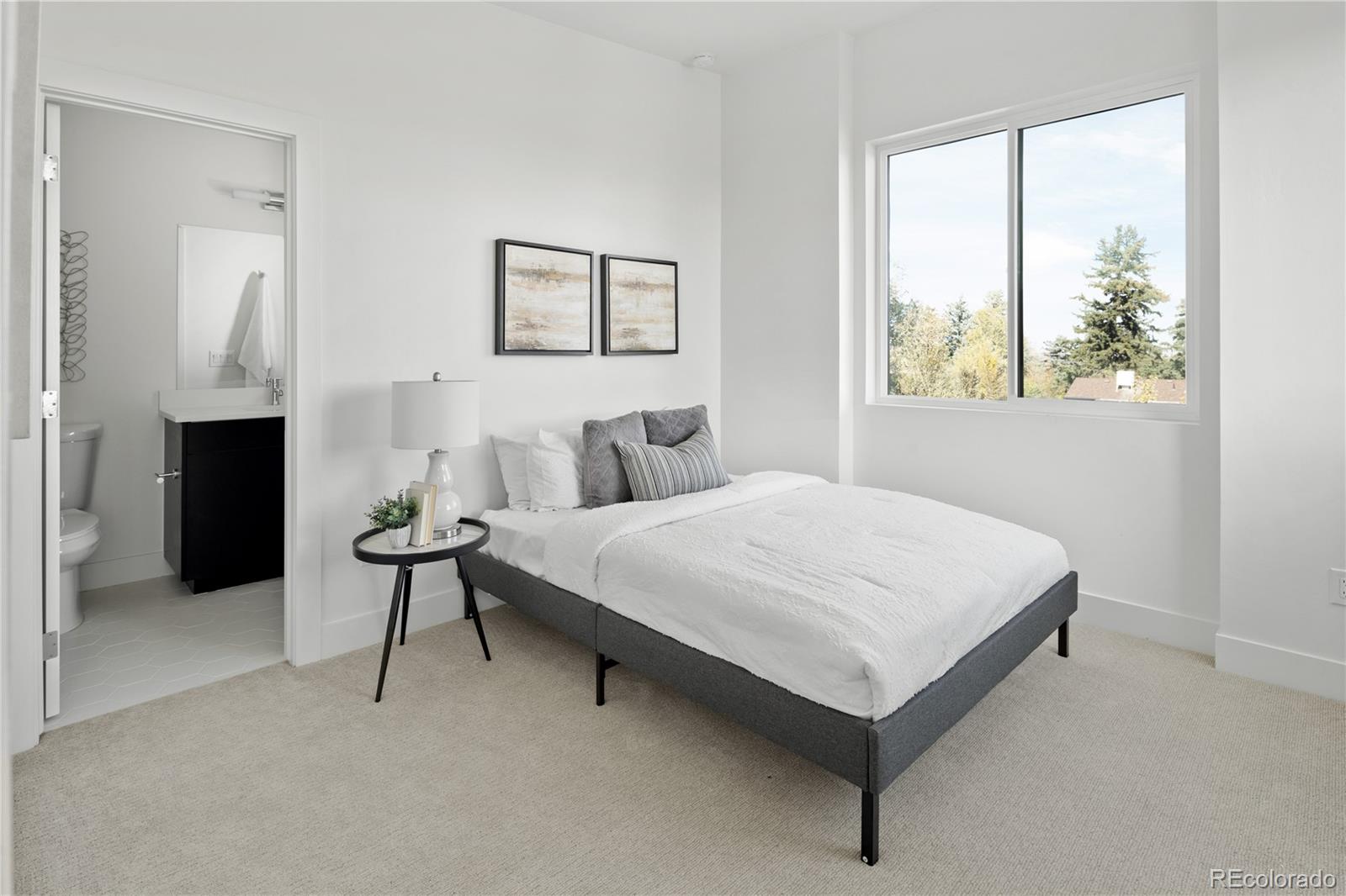 1686 Tabor Street Lakewood, CO 80215 - Photo 14 of 34 a bedroom with a bed and a painting on the wall