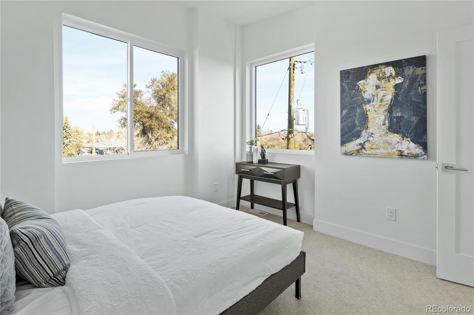 1686 Tabor Street Lakewood, CO 80215 - Photo 15 of 34 a bedroom with a bed table and window