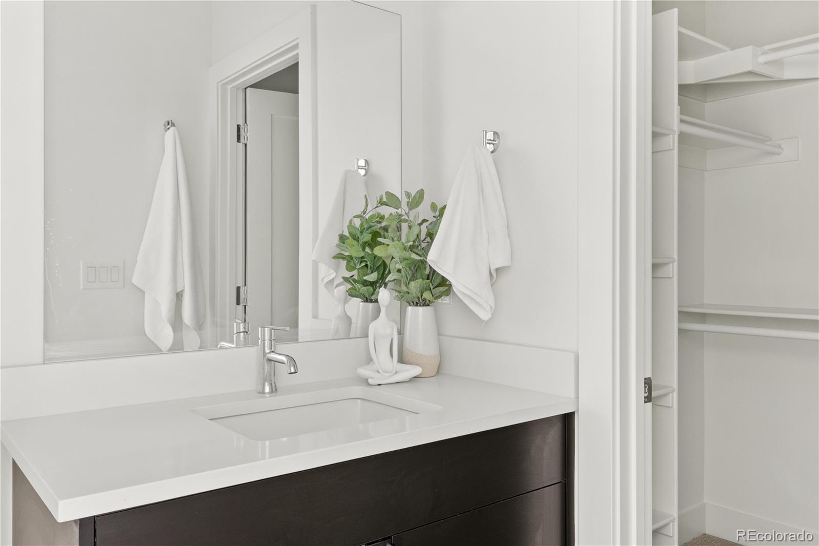1686 Tabor Street Lakewood, CO 80215 - Photo 16 of 34 a bathroom with a sink a vanity and a mirror