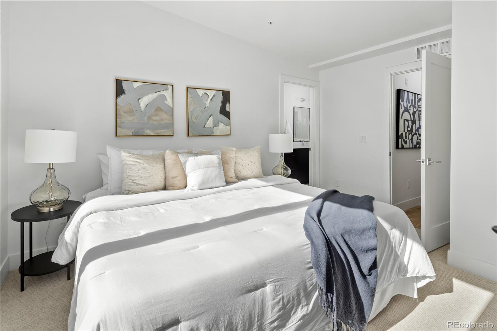 1686 Tabor Street Lakewood, CO 80215 - Photo 19 of 34 a bedroom with a bed and a painting on the wall